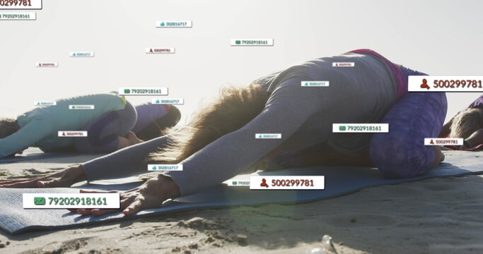 Image of social media notifications, over women doing yoga on beach - Powered by Adobe
