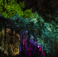 visual spectacle inside a cave in which colored lights are projected on its walls