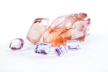 Rock, amethyst and pink diamond in studio with isolated white background for natural resource, jewel and sparkle for luxury. Gemstone, crystal and reflection in closeup for shine, glow and mineral