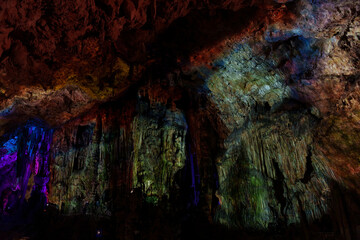 interior of a cave illuminated with colored lights