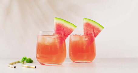 Two glasses of watermelon juice are on display, with copy space