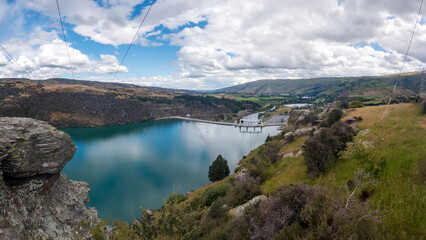 The Roxburgh Dam: Spectacular Scenery of Rolling Hills, Native Flora, and the Tranquil Clutha Mataau River and Lake Roxburgh Hydro Dam, New Zealand