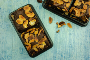 Package of chocolate brownie with nuts.