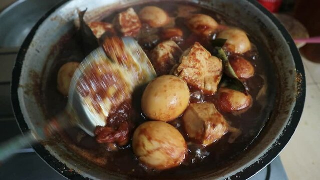footage of cooking tofu and eggs in sweet soy sauce sauce