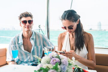 A couple is sitting on a boat in the ocean