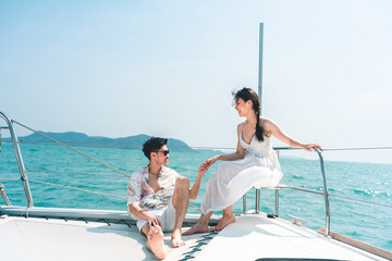 A couple is sitting on a boat in the ocean