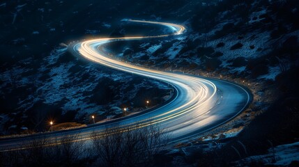 A car driving down a winding road at night.