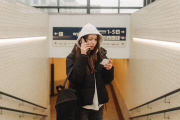 Tourist teenage girl at train station using smartphone map, social media check-in, or buy ticket booking. Modern travel app technology, lone traveler, Winter vacation railroad adventure concept - 757021600