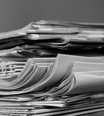 newspaper piled up on a table in a office with white background no people stock photo
