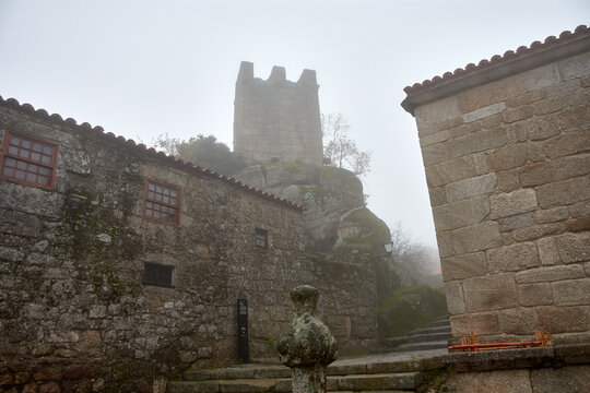 Narrow streets among the fog of the historic village of Sortelha in Portugal