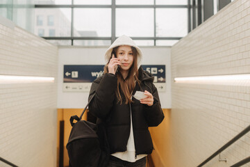 Tourist teenage girl at train station using smartphone map, social media check-in, or buy ticket booking. Modern travel app technology, lone traveler, Winter vacation railroad adventure concept - 757021847