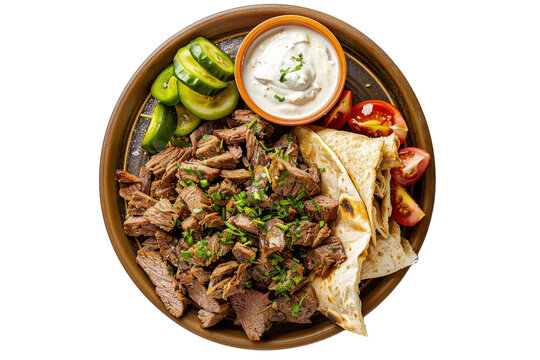 top view of a Lebanese shawarma plate, featuring thinly sliced marinated meat (usually lamb, beef, or chicken), served with garlic sauce, pickles, and flatbread.