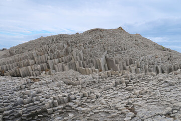texture of porous stones on the beach, nature, natural phenomena, grey stones, columnar stones,...