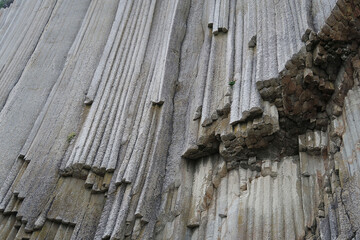 texture of porous stones on the beach, nature, natural phenomena, grey stones, columnar stones,...