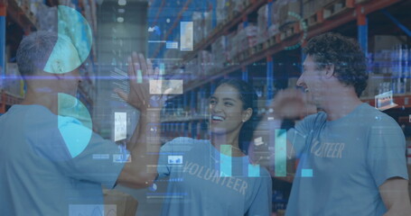 Image of statistics and financial data processing over men and woman high fiving in warehouse