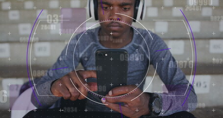 Image of digital data processing over male athlete using smartphone and headphones