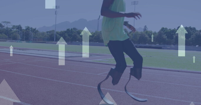 Image of arrows pointing up over disabled male athlete with running blades on running track - Powered by Adobe