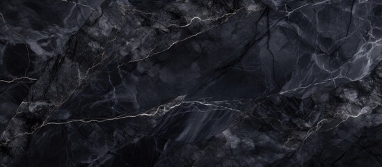 A detailed shot showcasing the intricate patterns and layers of a black marble texture, resembling a rugged natural landscape with hints of bedrock and rock formations