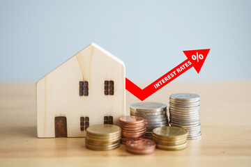 Interest of home loan. House and stack of money coin and percentage sign on red arrow rise up....