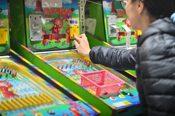 Taiwan - Feb 28, 2024: At a pinball stall in Ningxia Night Market in Taiwan, a close-up of a...