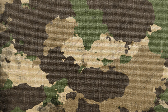 Texture of military dirty camouflage fabric. Combat protective camouflage for background