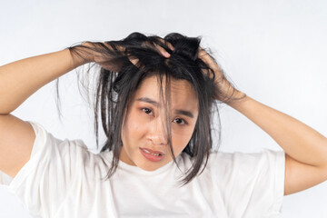 Fototapeta premium Broken hair, beautiful sad young woman with long disheveled hair, closeup photo of female model holding messy unbrushed dry hair in hand.