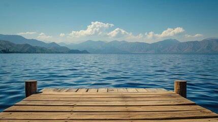 A wooden pier sits on the edge of a lake, with mountains in the background