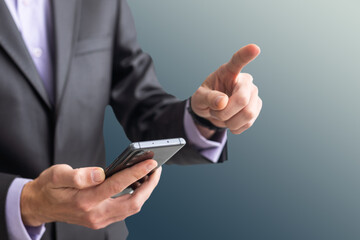 Businessman in the suit is using smartphone