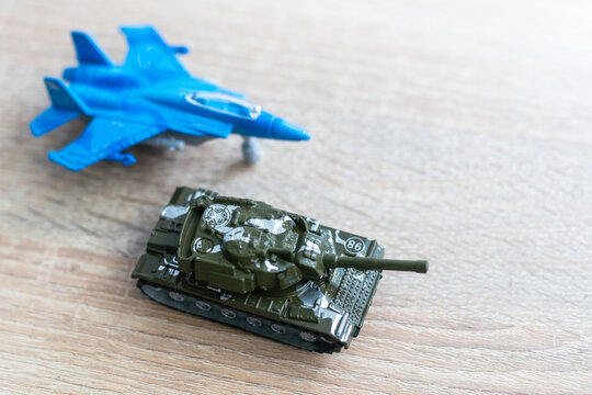 The image shows models of tanks and fighter jets on a white background, close up.