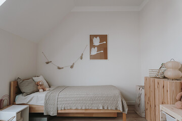 Modern minimal home interior design. Nursery room with bed, pillows, bed linen, plaid, toys,...