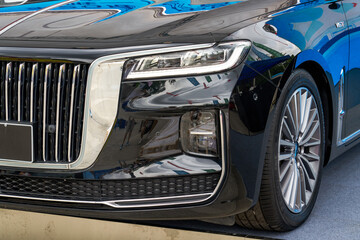 Close-up of the front and headlights of a luxury car