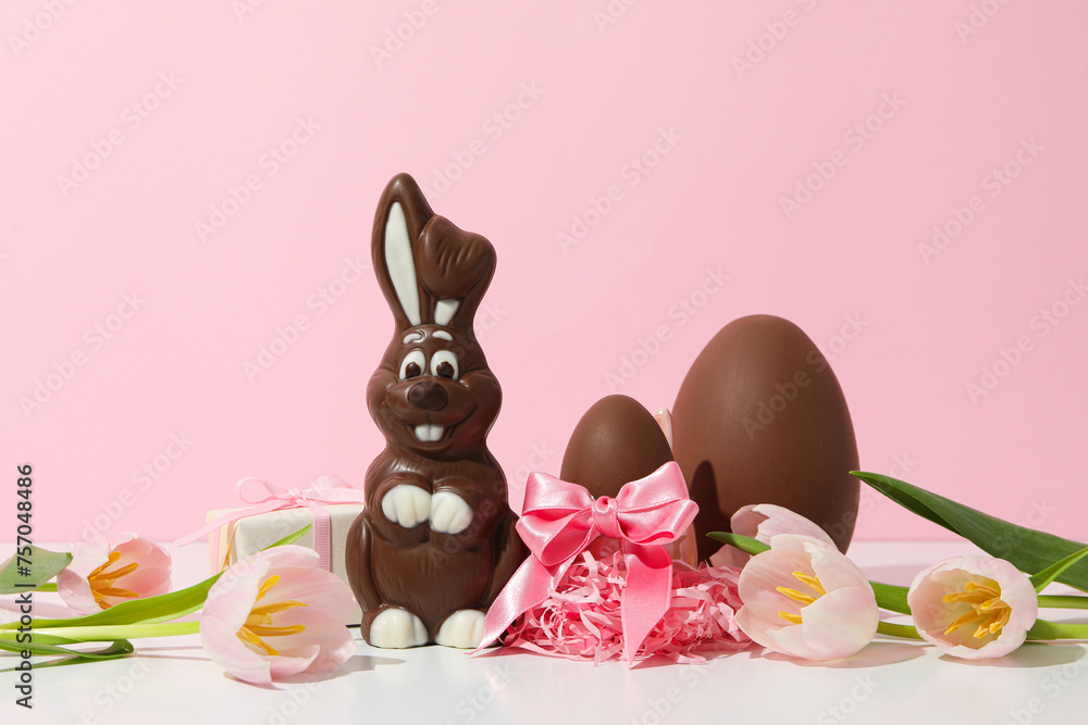 Wall mural Chocolate bunny with fresh flowers and gifts