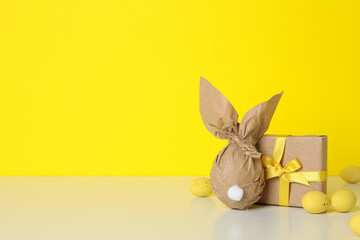 A chocolate egg in a wrapper and with a gift