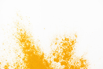 Scattered turmeric powder on white background, turmeric pattern and texture top view