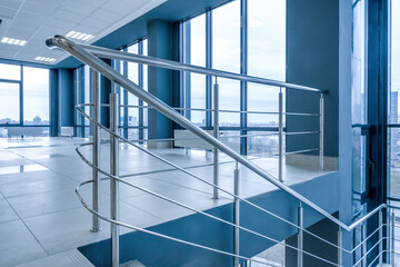 stairs emergency and evacuation exit stair in up ladder in a new office building in blue color...