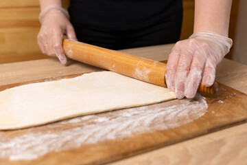 Preparation and rolling out puff pastry. Preparation of puff pastry dishes.