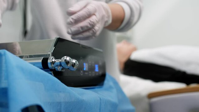 Beautiful woman receiving facial microcurrent treatment at spa salon. Beautician using electrical impulses for facial procedures. Woman in spa salon. Woman in a spa salon on cosmetic procedures.