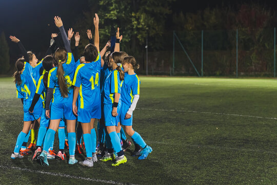 full shot of school girls football team getting ready with a coach for the match, soccer team concept. High quality photo