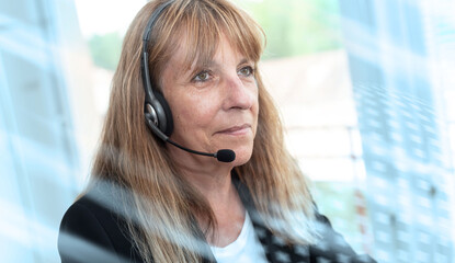 Female helpline operator in headset; light effect