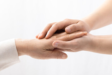 holding elderly's hand for comfort on white background.