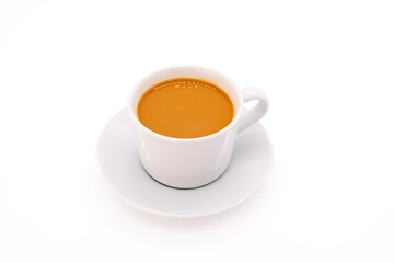 Creamy coffee on a white porcelain cup, isolated on white background with copy space.