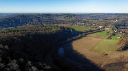 High-altitude drone photo of the Vézère Valley with the Château de Marzac, the troglodytic...