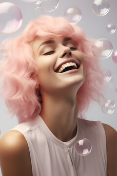 Closeup portrait of happy smiling young woman with pink hair and soap bubbles