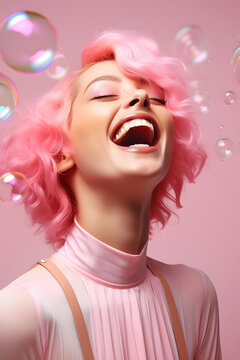 Closeup portrait of happy smiling young woman with pink hair and soap bubbles