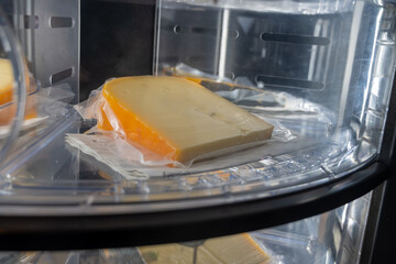 Sell of fresh farm cheese in automatic vending machine on organic cheese farm in Netherlands