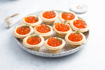 Red caviar served in tartlets