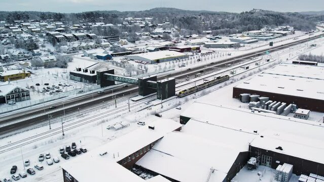 European Route E45 And Train Station With Snow-covered Surroundings In Winter. Alvangen In Vastra Gotaland, Sweden. aerial shot