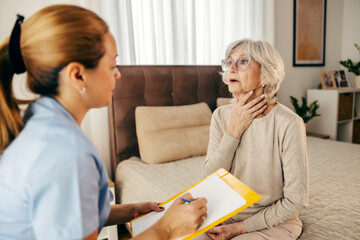 A senior woman with sore throat is talking with doctor during her home visit.