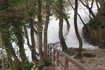 The offshot of a waterfall in Krka Nationalpark in Dalmatia, Croatia looks like a flash flood. - obrazy, fototapety, plakaty