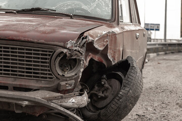 Broken car. Abandoned car on a city street along the road